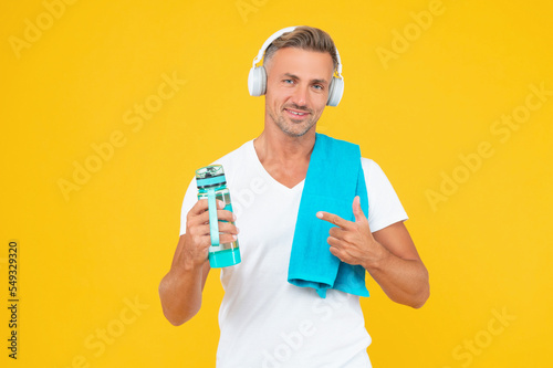 guy pointing finger on bottle for healthy lifestyle. guy with sport bottle for healthy lifestyle