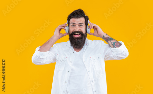 happy dj man in music headphones isolated on yellow background. dj man wearing music headphones