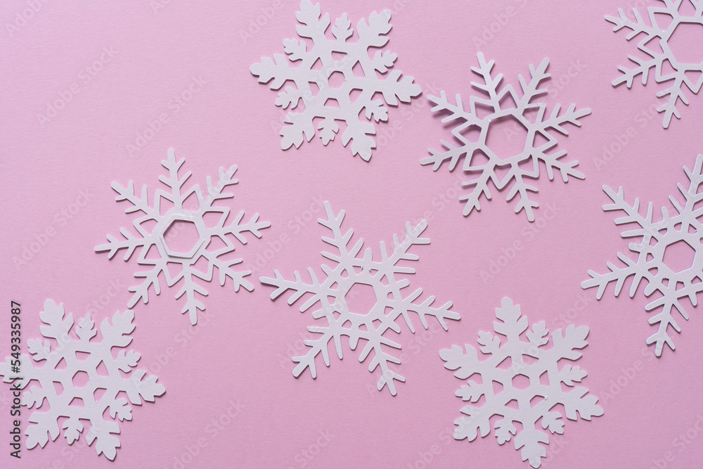 pink paper snowflakes on pink paper background