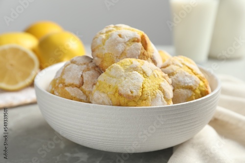 Delicious lemon cookies in bowl on grey table, closeup