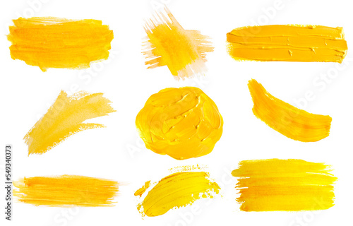 Different yellow paint strokes drawn with brush on white background, top view