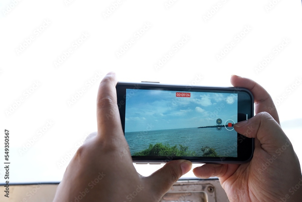 Photos of people using their phones to record video. Photos of people using their phones to record video.