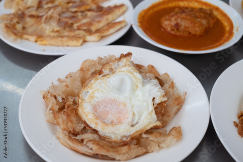 Fried Egg with Roti and Curry chicken, Thai spicy non-vegetarian food or recipe
