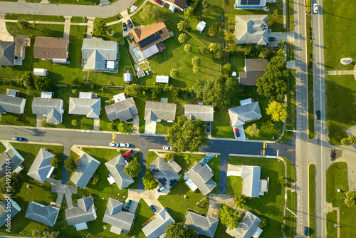Aerial view of small town America suburban landscape with private homes between green palm trees in Florida quiet residential area