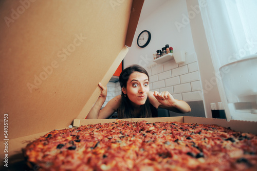 Gourmand Woman Wanting to Try a Pizza Slice. Funny adult person sneaking and stealing food in the kitchen
