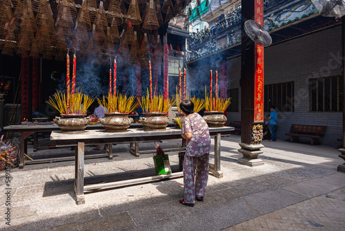 HO CHI MINH CITY, Vietnam - November 08, 2022 - Chua Ba Thien Hau Pagoda in Saigon. Inside Thien Hau Temple, Chinese-style temple of the Chinese sea goddess Mazu. People with burning incense praying.