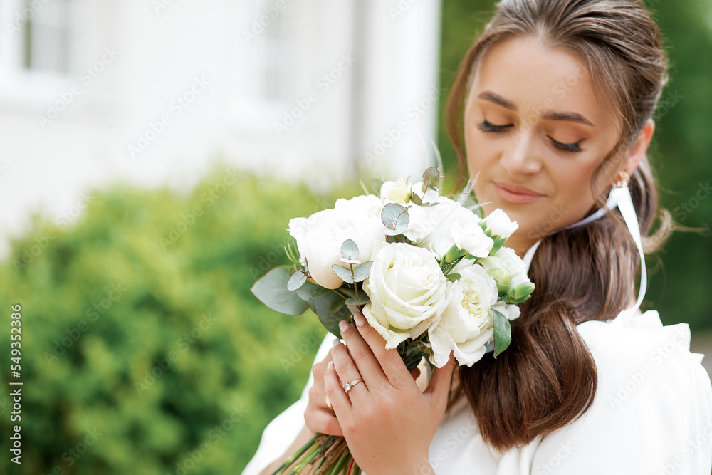 Sweet girl poses with a bouquet in her hands Sweet girl poses with a bouquet in her hands