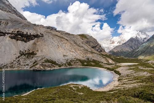 A Five colour lake landscape view; Snow mountain, crystal clear deep blue color of lake, blue sky at Yading National Nature Reserve, copy space for text, wallpaper, background