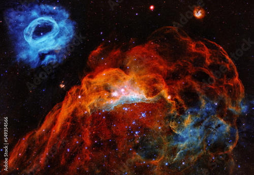 Large Magellanic Cloud in the Milky way showing a giant red nebula and a smaller blue nebula. Digitally enhanced. Elements of this image furnished by NASA.