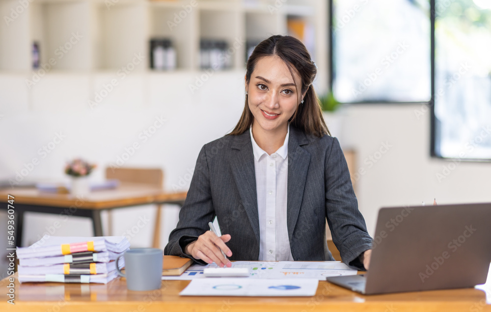 Asian female business analyst financial advisor preparing statistic report studying documents on work desk, Asian business woman work with documents in the office. Asian female business analyst financial advisor preparing statistic report studying documents on work desk, Asian business woman work with documents in the office.