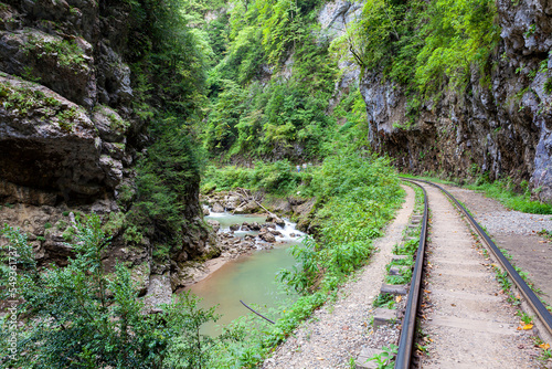 Narrow gauge railway in the deep narrow Guam canyon. Western Caucasus. Russia.