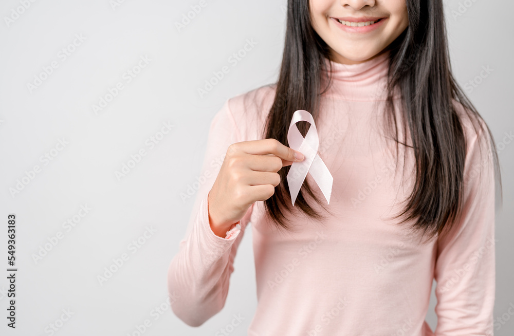 woman hands holding pink ribbon, Breast cancer awareness, world cancer day, national cancer survivor day in february concept... woman hands holding pink ribbon, Breast cancer awareness, world cancer day, national cancer survivor day in february concept...