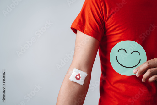 Obraz na plátne man hands holding smile face after donation blood, blood transfusion, world blood donor day, world hemophilia day concept