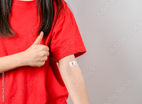 woman showing plaster after donation blood, blood transfusion, world blood donor day, world hemophilia day concept.