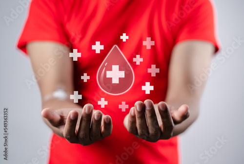 man hands holding virtual donation blood icon, blood transfusion, world blood donor day, world hemophilia day concept. photo