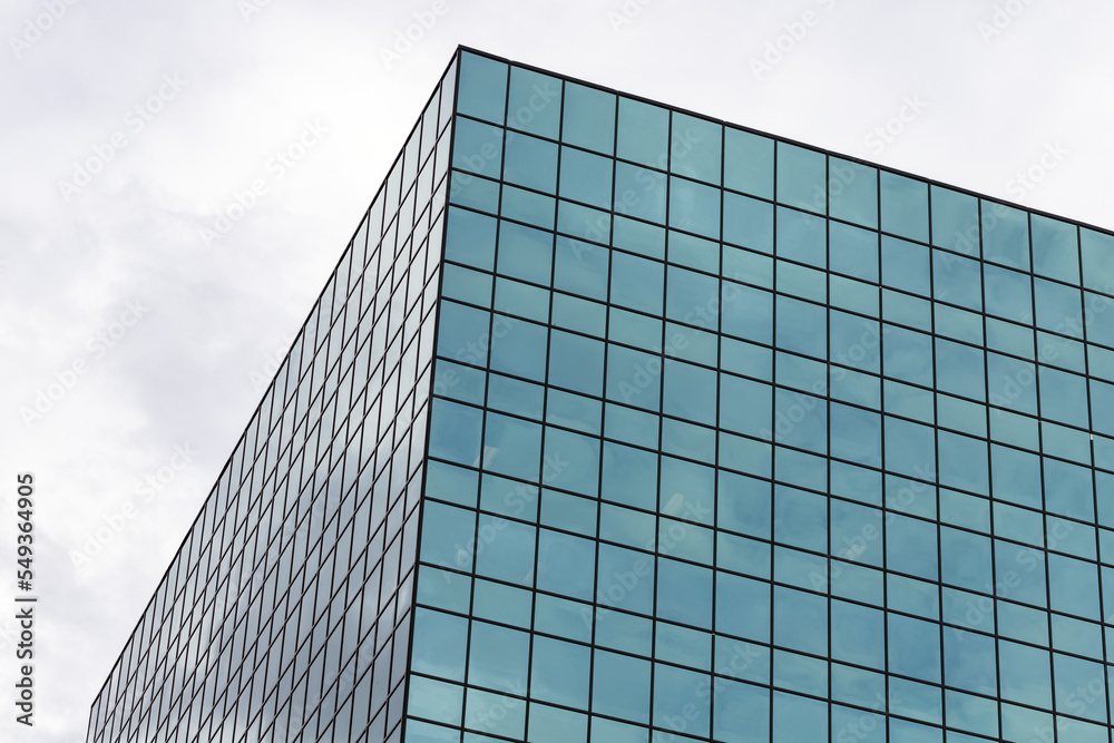 Skyscraper against sky, modern tall glass office building