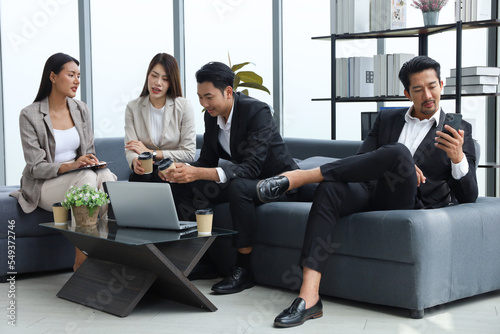 Business people relax meeting in office by using laptop computer and discussion or brainstorming
