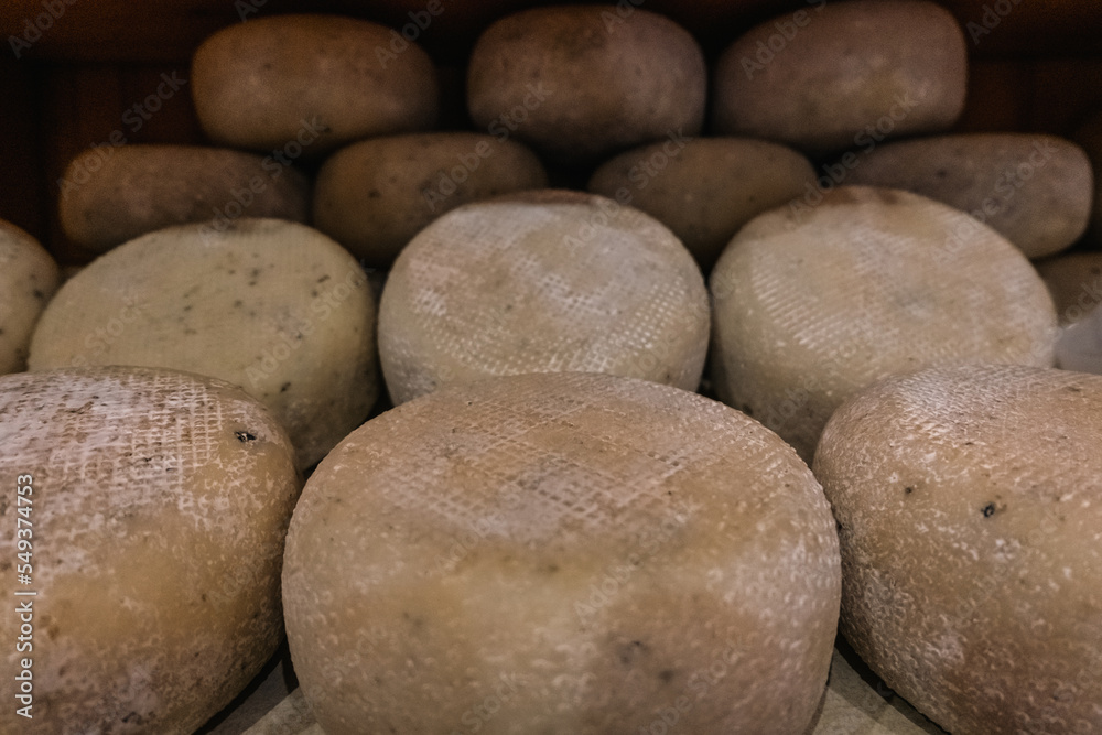 Artisan Pecorino cheese for sale on a Tuscany shop