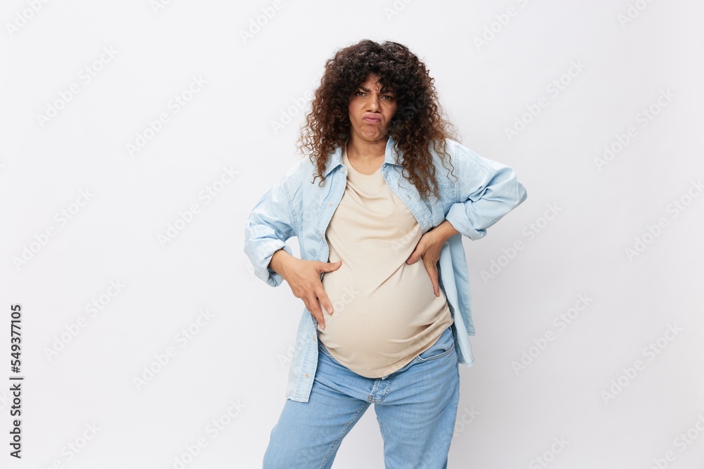 Pregnant woman smile maternity happiness belly in the last month of pregnancy on a white isolated background in a t-shirt with a blue shirt Pregnant woman smile maternity happiness belly in the last month of pregnancy on a white isolated background in a t-shirt with a blue shirt