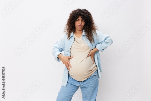 Pregnant woman smile maternity happiness belly in the last month of pregnancy on a white isolated background in a t-shirt with a blue shirt