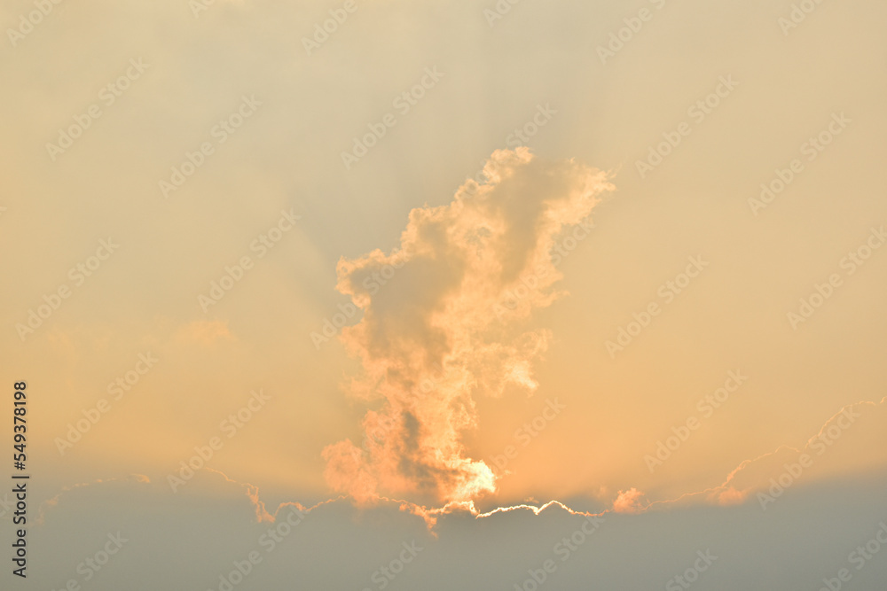 Dramatic sunset sky landscape background natural color of morning with setting sun rays coming through clouds ultra wide  view. Background of sky and sunrise.