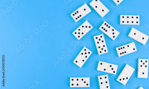 White dominoes randomly arranged on a blue background