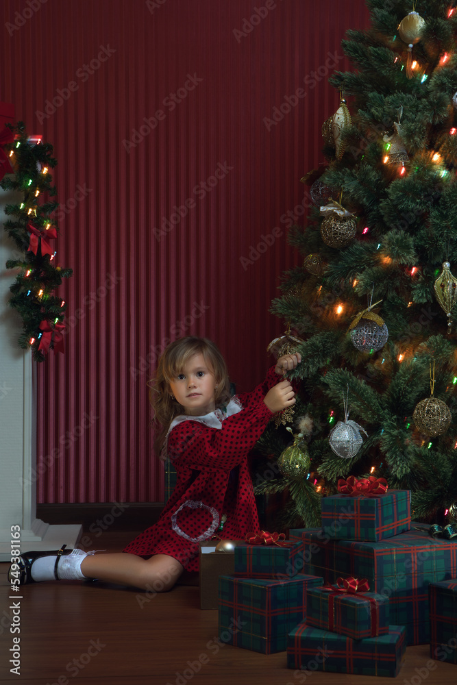 portrait of little girl is waiting for Santa coming in domestic environment