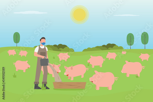Male farmer feeding his pigs in the farm