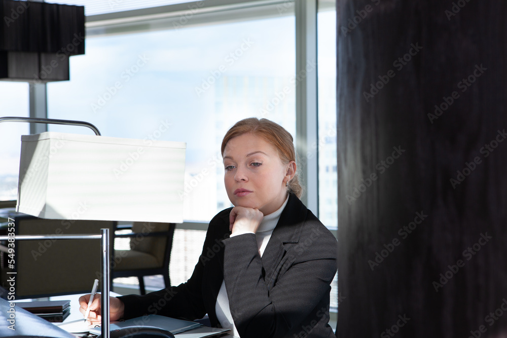 Portrait of young woman in black suit in office environment Portrait of young woman in black suit in office environment