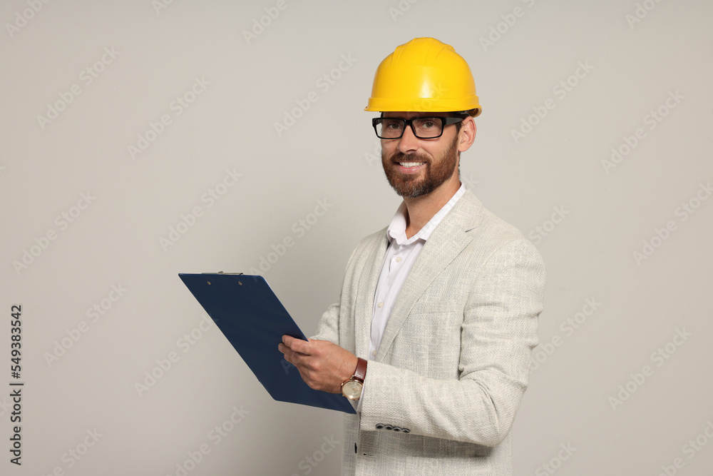 Professional engineer in hard hat with clipboard on white background Professional engineer in hard hat with clipboard on white background