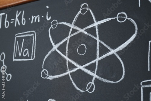 Different chemical formulas written with chalk on blackboard, closeup © New Africa