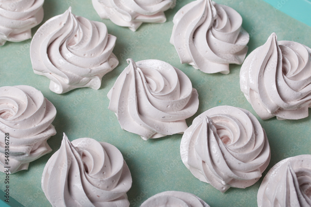 Homemade zephyr. White tray with marshmallows. Stands on black pine boards. Close-up. Homemade zephyr. White tray with marshmallows. Stands on black pine boards. Close-up.