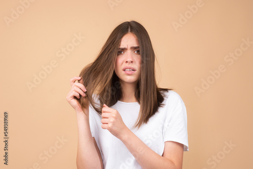 Sad woman with hair loss problem worried about hair loss.