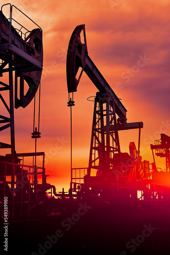 Prairie Oil Pump Jacks. One pump jack producing oil. Crude oil is a major economic driver. Abstract image