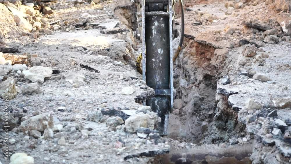 Destruction of solid soil rock with pneumatic jackhammer excavator ...