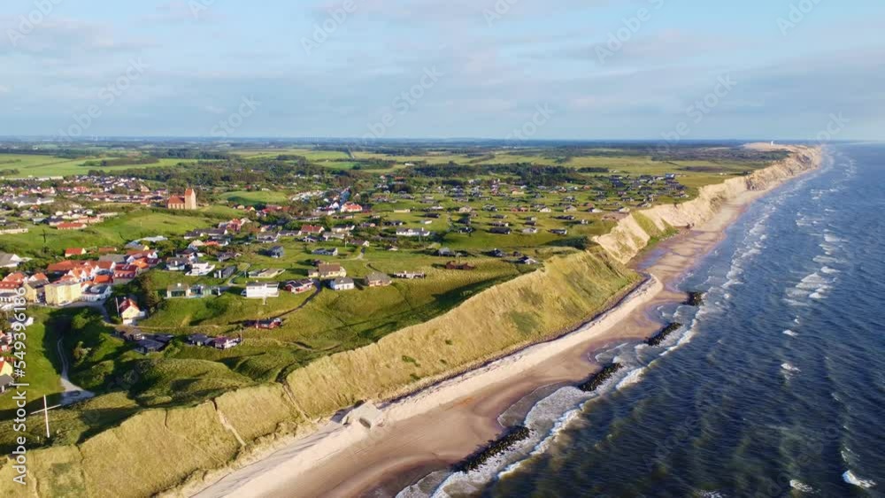 Aerial drone view of the idyllic coast line in Denmark around the village of Lønstrup on a summer day