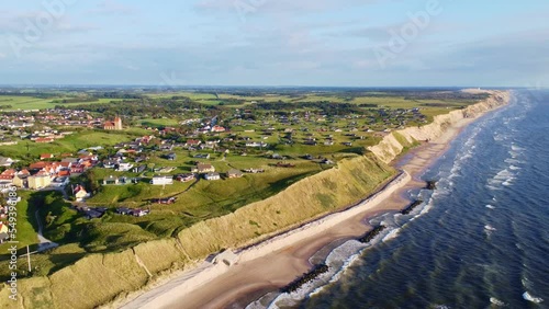 Aerial drone view of the idyllic coast line in Denmark around the village of Lønstrup on a summer day