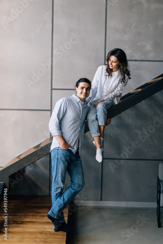 Young happy couple sitting on stairs at home © F8  \ Suport Ukraine