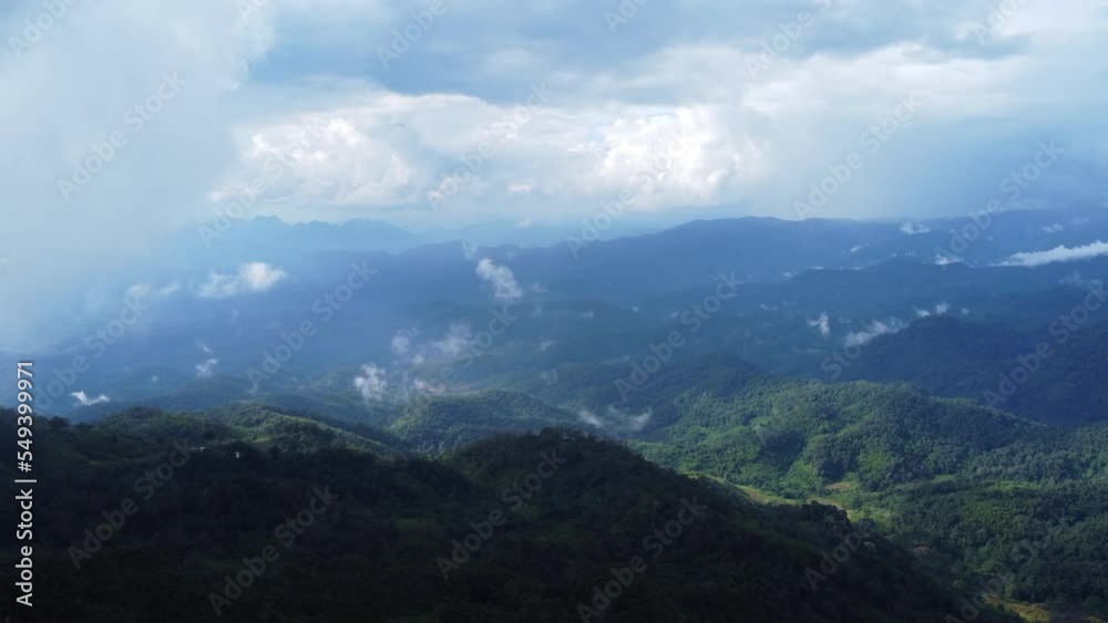 Aerial view of tropical forest with mist in the morning. Top view from drone of beautiful mountain tropical forest during winter in Thailand. Natural landscape background. Aerial view of tropical forest with mist in the morning. Top view from drone of beautiful mountain tropical forest during winter in Thailand. Natural landscape background.
