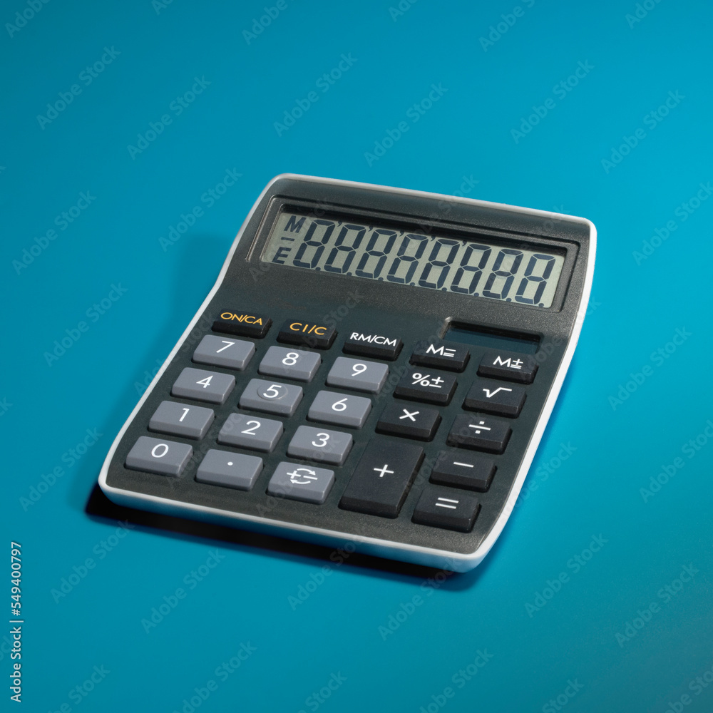 Desktop calculator with activated all the symbols on the scoreboard. on a blue background. square format Desktop calculator with activated all the symbols on the scoreboard. on a blue background. square format