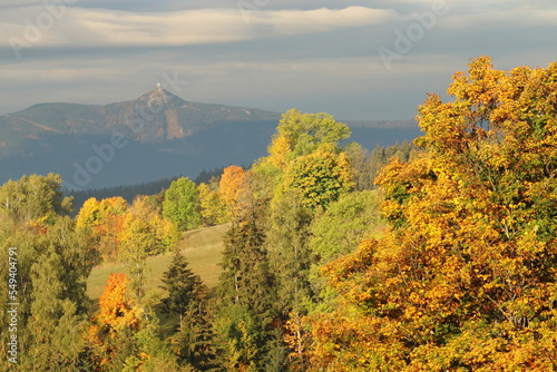 the top of the Jizera Mountains Ještěd, autumn trees in the foreground  © Jitka