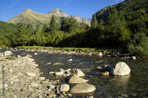 Bujaruelo Valley in the Pyrenees mountains in spring with the Ara river in foreground photo