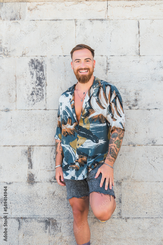 Bearded man leaning on shabby wall Bearded man leaning on shabby wall