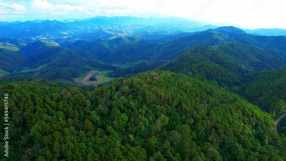 Aerial view over the green tropical forest and agricultural land, scenery at sunset. Mae Hong Son Province, Northern Thailand. countryside landscape. Plants, Flowers and Transport concept. 4K
Aerial view over the green tropical forest and agricultural land, scenery at sunset. Mae Hong Son Province, Northern Thailand. countryside landscape. Plants, Flowers and Transport concept. 4K