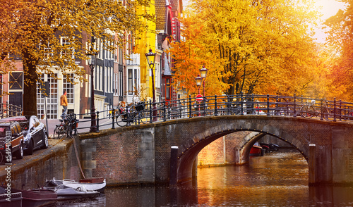 Channel in Amsterdam Netherlands houses river Amstel landmark old european city autumn landscape.