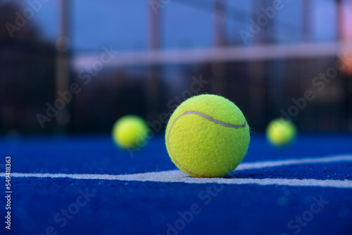 selective focus, three balls on an artificial grass paddle tennis court