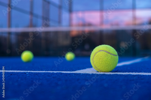 selective focus, three balls on an artificial turf paddle tennis court © Vic