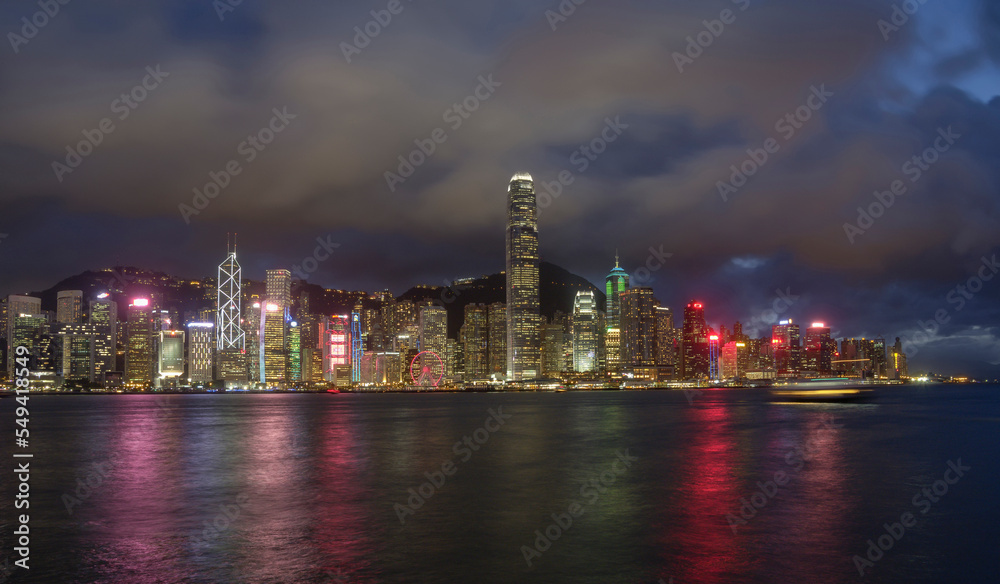 Night landscape / skyline of Hong Kong Harbour, showing neon-lit skyscrapers.