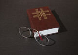 A reading pince-nez and a Christian prayer book