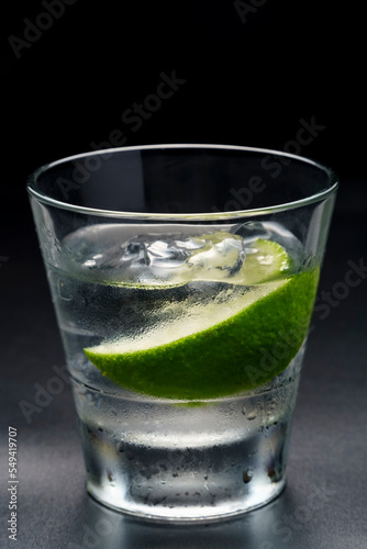 Luxury cocktail Vodka lime mojito, gin tonic with ice, tequila in rocks-glass on black background.